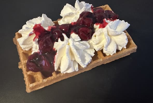 Gofr z bitą śmietana i wiśniami w żelu
